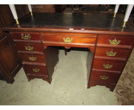 A late 19th century mahogany knee hole twin pedestal desk, the rectangular top with inset writing surface over an arrangement