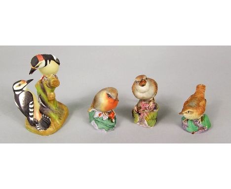Four Royal Worcester matt glazed figures of birds including pied woodpeckers, nightingale, etc