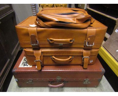 A vintage brown fibre and steel re-enforced cabin trunk with Cunard shipping label together with three further items of lugga