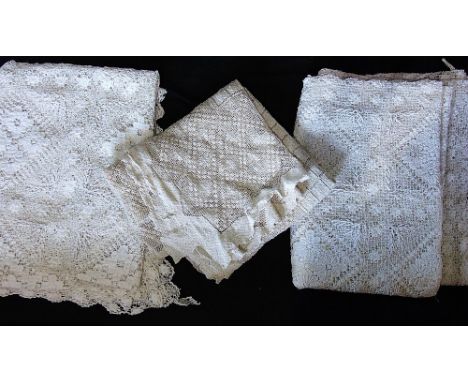 Three vintage table coverings, each with open weave and intricate patterning