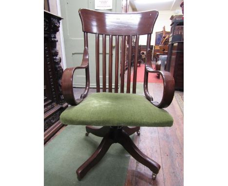 An Edwardian ashwood office chair with stick back and scrolled arms raised on a swivel base