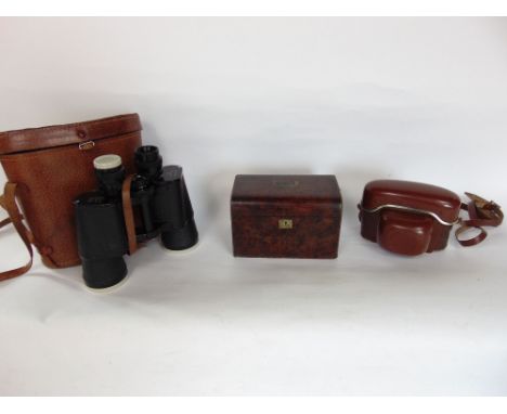 19th century burr wood tea caddy, the hinged lid enclosing a fitted interior; together with a vintage set of binoculars (3)