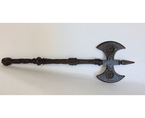 A wrought iron battle axe with fleur de lys roundel's and floral trails, 53cm long