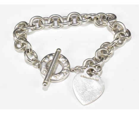 TIFFANY &amp; CO; a sterling silver curb link bracelet with T-bar and heart shaped clasp, length 21cm, with box and original 