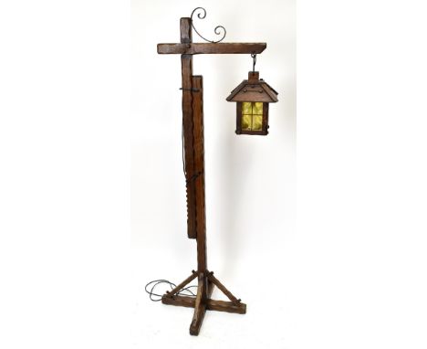 A carved oak adjustable standard lamp, with lantern light, height 144cm