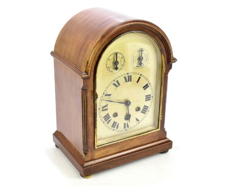 An early 20th century mahogany cased bracket clock of arched form, the silvered dial with slow/fast and chime/silent dials, t
