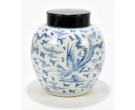 A 19th century Chinese blue and white porcelain ginger jar with associated wooden cover, decorated with four claw dragon chas