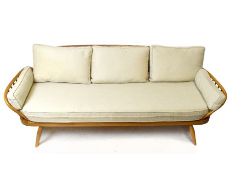 LUCIAN ERCOLANI FOR ERCOL; a light elm and beech framed studio couch with spindle legs, width 200cm.Additional InformationLig