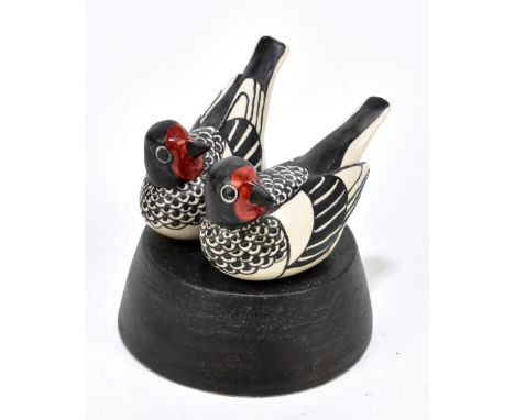 NORMAN MAKINSON (1921-2010); a Studio Pottery model of two birds on a circular tapering plinth base, height 12cm, length 10.5