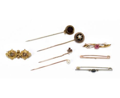 A 9ct yellow gold bar brooch set with central pink coloured stone, two further bar brooches including an Edwardian white meta