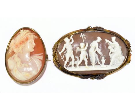 Two late Victorian gilt metal cameo brooches, one decorated with a portrait of a maiden, the other with a pastoral scene, lon