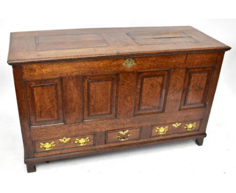 An 18th century oak crossbanded mule chest with panelled front and three base drawers on bracket feet, width 147cm, depth 57c