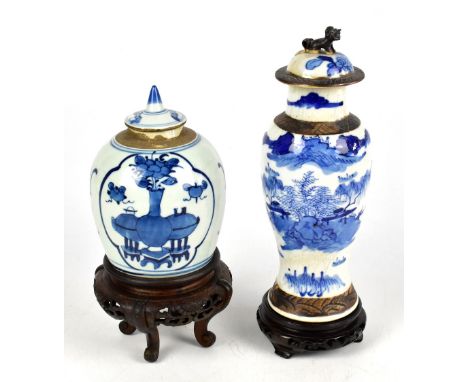 A Chinese blue and white crackle glaze vase and cover, decorated with a landscape, height 27cm, on a modern carved wood stand