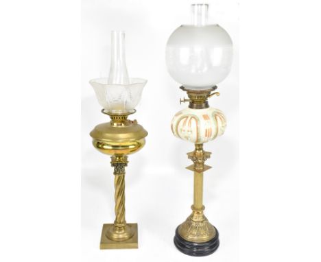 Two late 19th century brass oil lamps including example with opaque moulded glass reservoir and frosted and clear glass shade