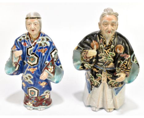Two Japanese porcelain figures of elders wearing kimonos, each bears iron red signature to underside, height 26cm (2).Additio