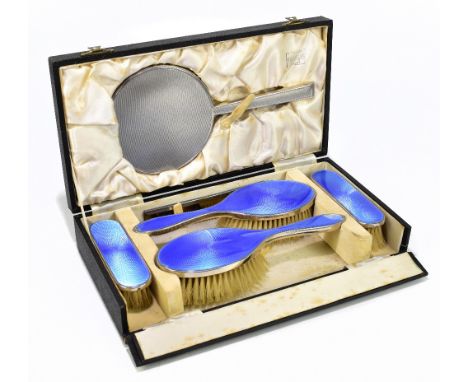 LANSON LTD; a George V hallmarked silver and blue guilloche enamel four piece dressing table set, Birmingham 1934, and a matc