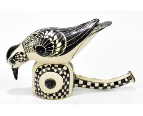 NORMAN MAKINSON (1921-2010); a Studio Pottery model of a bird perching on a stylised branch, with hand painted detail, inscri