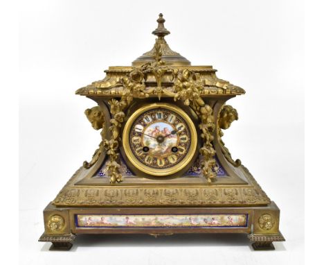 A French style brass mantel clock with enamel face decorated with cherubs, with Roman numerals, height 30cm, width 31cm, dept