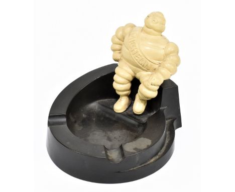 MICHELIN; an original Art Deco advertising ashtray representing Mr Bibendum seated on a bakelite base, stamped 'Made in Engla