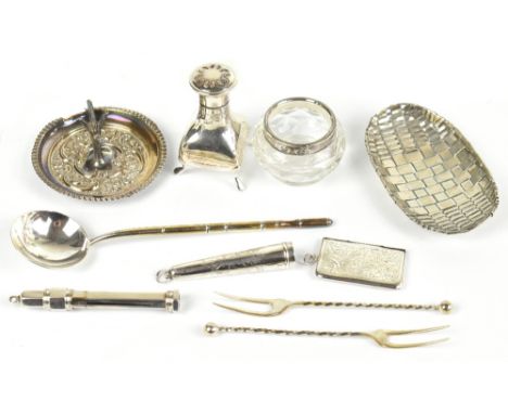 A group of silver and white metal including a pepper, a pair of pickle forks, ring stand, etc.