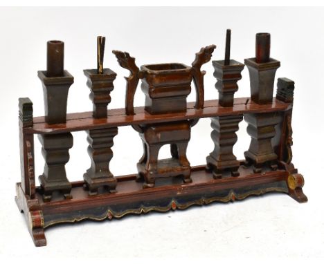 A large Chinese carved and painted wood altar piece&nbsp;with central twin handled vase and four candlesticks, on polychrome 