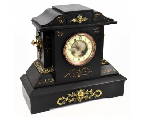 A Victorian slate mantel clock with applied gilt metal detail and carved decoration with gilt highlights, the circular dial s