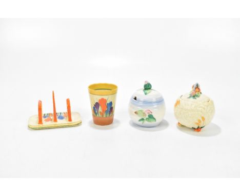 CLARICE CLIFF; a three bar toast rack decorated in the 'Crocus' pattern, width 12.5cm, together with a beaker decorated in th