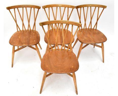 ERCOL; a set of four light elm seated stick back chairs.