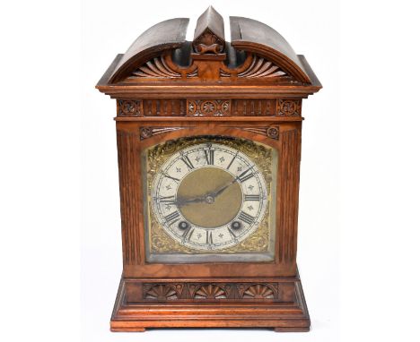 LENZKIRCH; an early 20th century German walnut cased mantel clock with carved decoration surrounding the brass face with appl