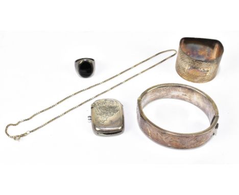 A hallmarked silver bangle with engraved detailing, and a silver napkin ring, vesta case, a white metal ring and a further wh