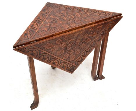 A late 19th century carved oak drop leaf table of triangular carved claw feet, height 64cm, width 79cmAdditional InformationG