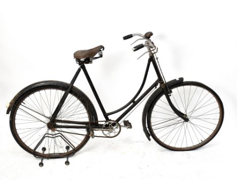 A vintage lady's Triumph bicycle with leather seat (attention needed), height 103cm.Additional InformationThe bike does have 