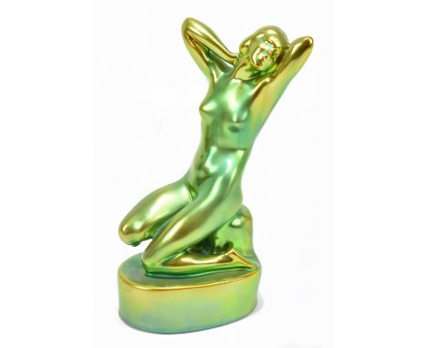 ZSOLNAY PECS; a Hungarian lustre glazed figure of a kneeling nude maiden, printed marks to the underside, height 24cm.Additio