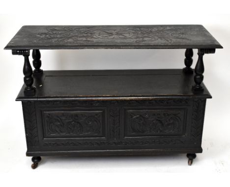 A late Victorian carved and stained wood monk's bench, on castors, height 85cm, length 122cm