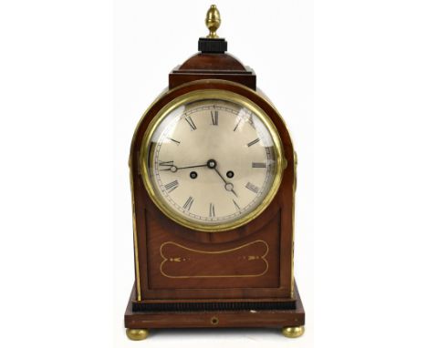 An early 20th century French mahogany and brass applied mantel clock in the 19th century style, the silver dial with Roman nu