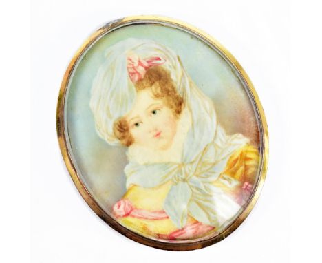 CIRCA 1900 ENGLISH SCHOOL; watercolour on ivory, portrait miniature of a maiden in an elaborate bonnet, in gilt metal frame, 