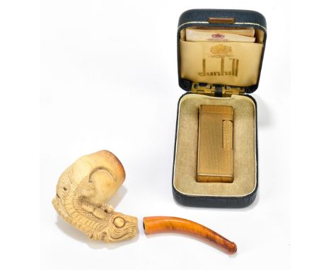 A late 19th century meerschaum type pipe with claw detail, and a cased Dunhill gold plated lighter (2).