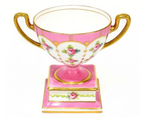 MINTON; a twin handled pedestal vase on a stand, painted with roses on a salmon ground, height 12cm.Additional InformationLig