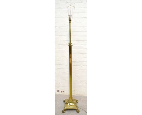 An Edwardian Adam style lacquered brass adjustable standard lamp on swept circular base and cast claw and ball feet, height 1