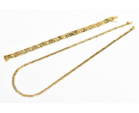 A yellow metal necklace with pierced Greek key decoration, length 45cm, with matching bracelet, length 18cm, each stamped 585