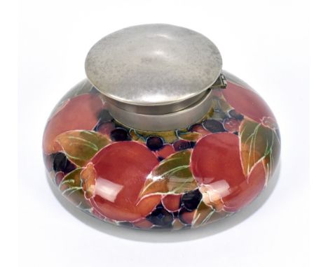 WILLIAM MOORCROFT; a squat inkwell decorated in the 'Pomegranate' pattern on a blue ground, with pewter collar and cover, gre