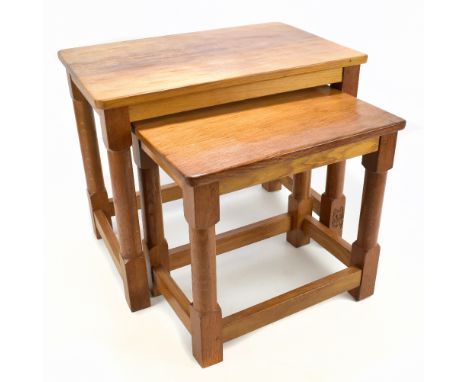 LYNDON HAMMELL OF HARNBY; a Cat and Mouseman oak nest of two graduated coffee tables, with adzed decoration to the top, on co
