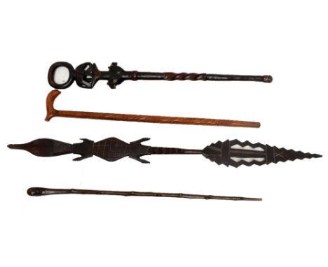 A 20th century African walking stick with carved detail of an elephant and lion heads, height 90cm, and an African paddle, a 
