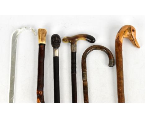 A collection of six early 20th century and later walking canes, to include a horn handled example with silver collar, London 