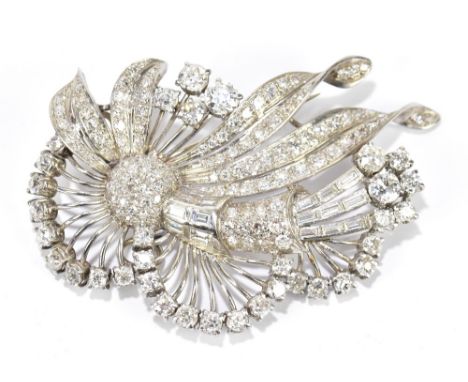 A platinum and diamond large floral spray brooch featuring round brilliant cut stones and emerald cut stones to the frame, di