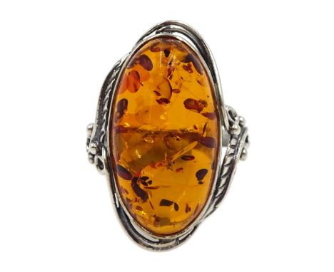 Silver oval Baltic amber ring, with leaf design gallery, stamped 925 Condition Report:Size R, max depth = 26mm, good conditio