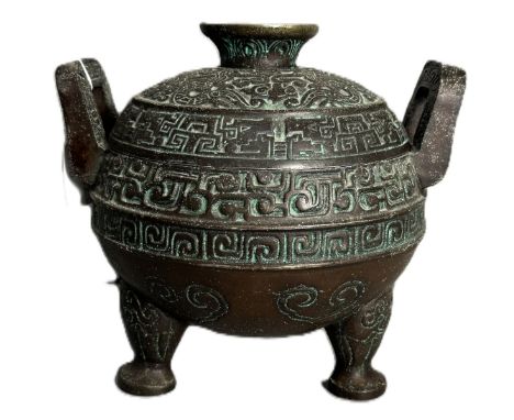 A mid-century ice bucket in the manner of JAMES MONT, Chinese style with handles to side on tripod supports, having image to 