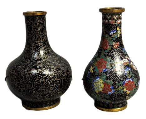 A Chinese cloisonne bottle with floral and butterfly decoration, 10 cm, and another, (2).    The polychrome floral vase has a