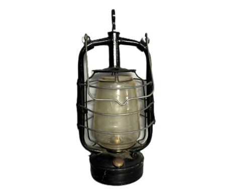 A vintage oil lamp with several protective bars and shade having a V inside trefoil, 39cm.&nbsp;