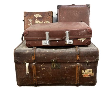 A vintage traveling trunk with wooden banding and travel stickers, 43 x 80 x 53 cm, along with three vintage traveling cases,